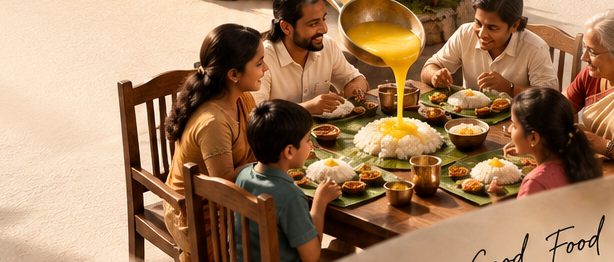 Three generations of a family sharing a meal together, ghee being poured over rice